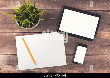 workspace with digital tablet, phone and blank paper on wooden table Stock Photo