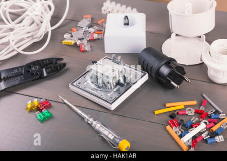 electrician tools and accessories on wooden table Stock Photo