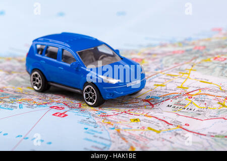 road trip, small toy car on map Stock Photo
