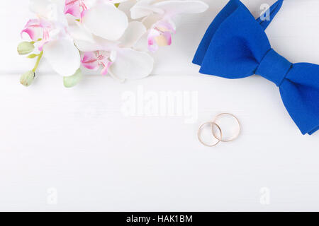 wedding background with golden rings on white wooden table Stock Photo