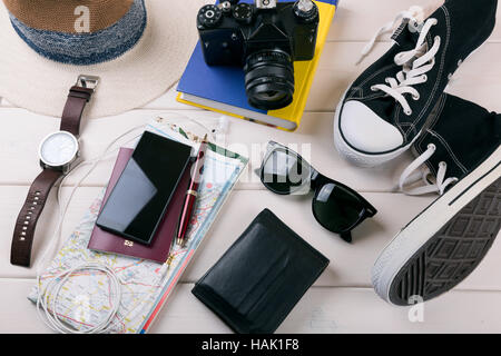 travelers vacation items on white wooden table Stock Photo
