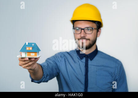 construction engineer showing small house model Stock Photo