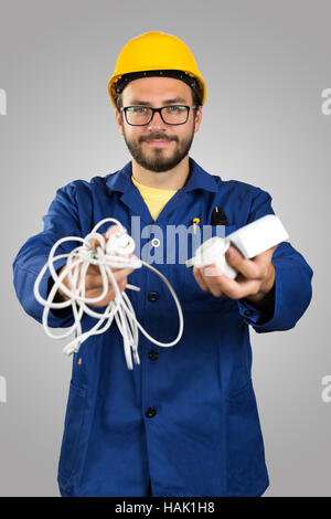 smiling electrician with tools isolated on gray background Stock Photo