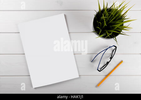 mockup with blank magazine cover on white wooden table Stock Photo