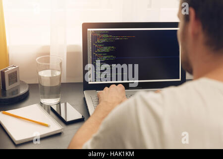 website programmer working on laptop at office Stock Photo