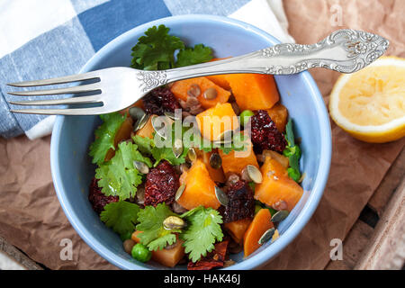 Vegan garnish. Boiled sweet potatoes with green peas, cilantro and linseed oil. Perfect for the detox diet or just a healthy meal.  Love for a healthy Stock Photo