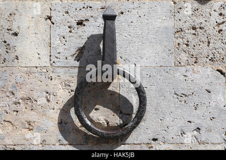 Old metal ring on a white wall. Historical Building in Italy Stock Photo