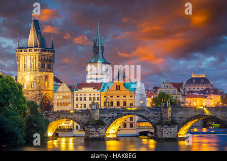 Vibrant stormy sunset sky over the River Vltava and Charles Bridge Prague Czech Republic Europe