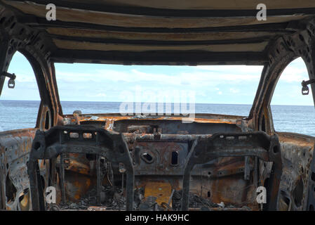 burned down car wreck - damaged car Stock Photo