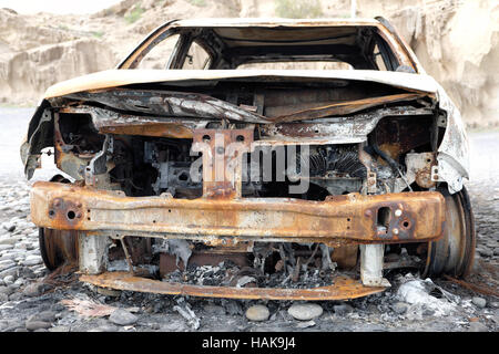 burned down car wreck - damaged car Stock Photo