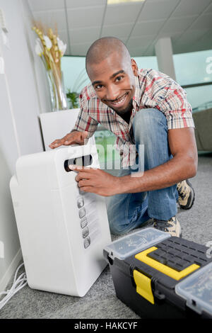 Repairing an air conditioning unit Stock Photo