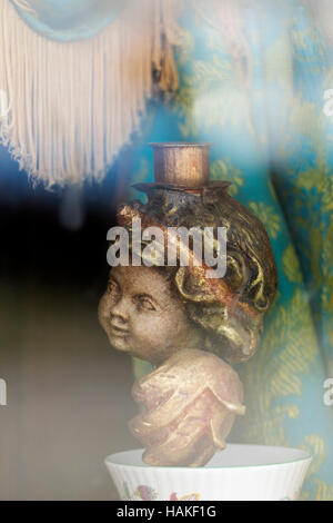 Angel candle holder sitting in window of building with fringed curtain at Barkerville Historic Town, British Columbia, Canada Stock Photo