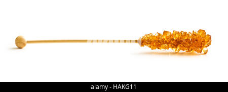 Brown amber sugar crystal on wooden stick isolated on white background. Stock Photo