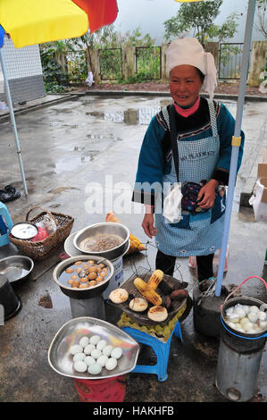 Vendors often sell food along the roadway in some areas of China. Stock Photo