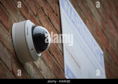 mounted on a church building CCTV cameras hidden on wall Stock Photo