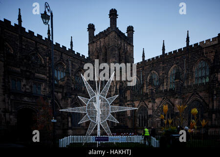 Chester Cathedral neon star large   exterior Christmas xmas festive seasonal market stalls gift  Market bazaar vendor trader traders independent shops Stock Photo