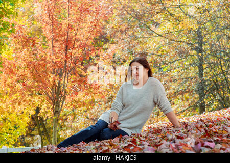 Autumn woman on leafs background Stock Photo