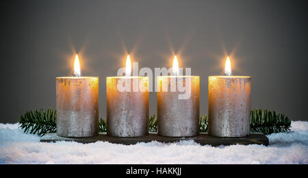 Light four advents candles with matches Stock Photo