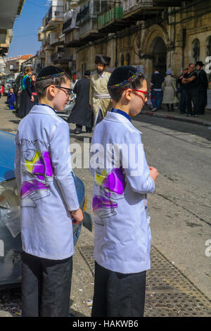 JERUSALEM, ISRAEL - MARCH 25, 2016: Street scene of the Jewish Holyday Purim, with locals, some wearing costumes, in the ultra-orthodox neighborhood M Stock Photo