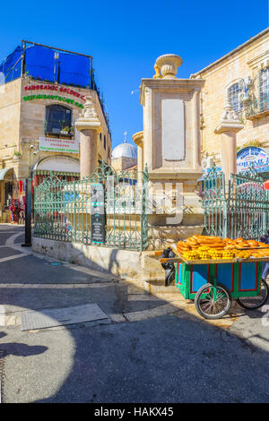 JERUSALEM, ISRAEL - APRIL 29, 2016: Street scene in the Muristan Complex, with local businesses, locals and visitors, in the old city of Jerusalem, Is Stock Photo