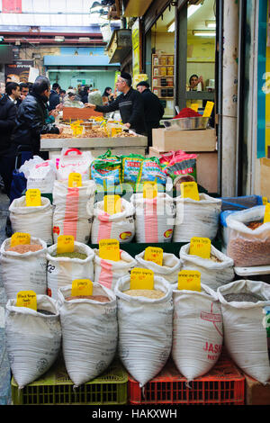 JERUSALEM, ISRAEL - JAN 16, 2015: Market scene with seller and shoppers in the Mahane Yehuda Market, in Jerusalem, Israel. It is the main market in we