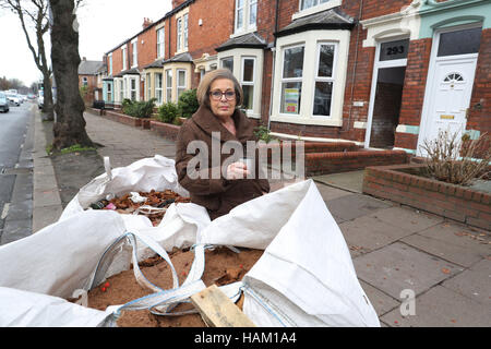 Pensioner Anne Reay from Warwick Road in Carlisle sits outside her home - one of hundreds of people facing another miserable festive season a year on from Storm Desmond. Stock Photo