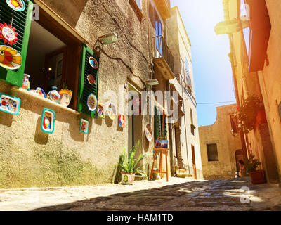 Sicilian souvenirs. Ancient, typical narrow and cobblestone street in Erice, Sicily, Italy. Stock Photo