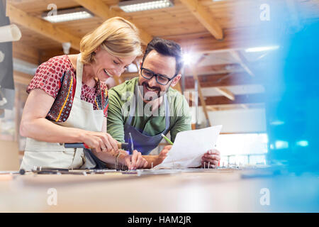 Artists working in studio with hammer in nails Stock Photo