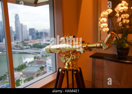 SINGAPORE - JULY 23rd, 2016: luxury Hotel room or suite with modern interior, an awesome view of the Marina Bay, golden binoculars Stock Photo