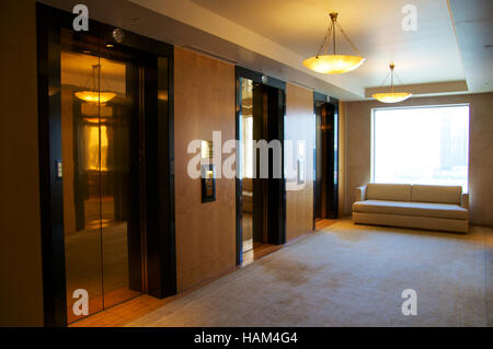 SINGAPORE - JULY 23rd, 2016: Three elevators in a luxury Hotel lobby with an awesome view of the Marina Bay Stock Photo