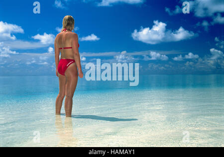 Woman, 20 year-old, looking out over the ocean to the horizon, Summer Island Village, North Male Atoll, Maldives, Indian Ocean Stock Photo