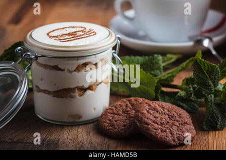 Concept: restaurant menus, healthy eating, homemade, gourmands, gluttony. Tiramisu dessert with cookies on weathered wooden table Stock Photo