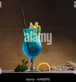 Concept: restaurant menus, healthy eating, homemade, gourmands, gluttony. Blue Lagoon Cocktail on gritty vintage background Stock Photo