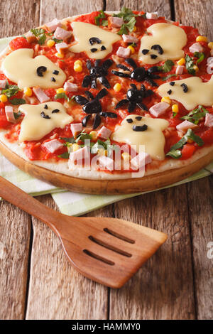 Pizza Halloween with ghosts cheese and olives spiders close-up on the table. vertical Stock Photo