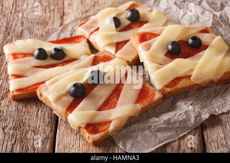 terrible sandwiches for Halloween in the form of a mummy on the table. Horizontal Stock Photo