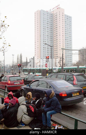 Paris France 2nd December 2016 Migrants from Sudan sit by the road side near Camp for Migrants in Porte De La Chapelle in northern Paris. Credit:  Thabo Jaiyesimi/Alamy Live News Stock Photo