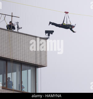 London, UK.  2 December 2016.  A participant takes place in a zip-wire challenge from the roof of St. Thomas' Hospital, over the River Thames to Victoria Tower Gardens next to the Houses of Parliament.  20 participants are each reported to have raised GBP50,000 each to reach GBP1m for the Evelina London Children's Hospital. Credit:  Stephen Chung / Alamy Live News Stock Photo