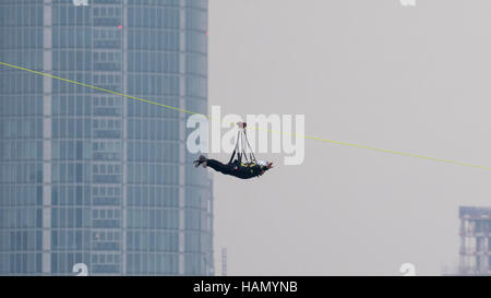 London, UK.  2 December 2016.  A participant takes place in a zip-wire challenge from the roof of St. Thomas' Hospital, over the River Thames to Victoria Tower Gardens next to the Houses of Parliament.  20 participants are each reported to have raised GBP50,000 each to reach GBP1m for the Evelina London Children's Hospital. Credit:  Stephen Chung / Alamy Live News Stock Photo