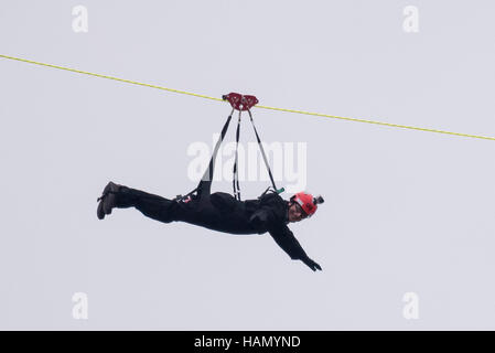 London, UK.  2 December 2016.  A participant takes place in a zip-wire challenge from the roof of St. Thomas' Hospital, over the River Thames to Victoria Tower Gardens next to the Houses of Parliament.  20 participants are each reported to have raised GBP50,000 each to reach GBP1m for the Evelina London Children's Hospital. Credit:  Stephen Chung / Alamy Live News Stock Photo