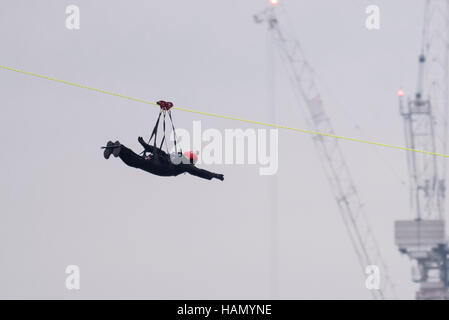 London, UK.  2 December 2016.  A participant takes place in a zip-wire challenge from the roof of St. Thomas' Hospital, over the River Thames to Victoria Tower Gardens next to the Houses of Parliament.  20 participants are each reported to have raised GBP50,000 each to reach GBP1m for the Evelina London Children's Hospital. Credit:  Stephen Chung / Alamy Live News Stock Photo