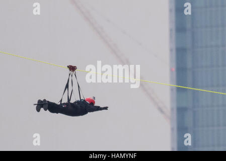 London, UK.  2 December 2016.  A participant takes place in a zip-wire challenge from the roof of St. Thomas' Hospital, over the River Thames to Victoria Tower Gardens next to the Houses of Parliament.  20 participants are each reported to have raised GBP50,000 each to reach GBP1m for the Evelina London Children's Hospital. Credit:  Stephen Chung / Alamy Live News Stock Photo