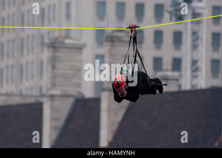 London, UK.  2 December 2016.  A participant takes place in a zip-wire challenge from the roof of St. Thomas' Hospital, over the River Thames to Victoria Tower Gardens next to the Houses of Parliament.  20 participants are each reported to have raised GBP50,000 each to reach GBP1m for the Evelina London Children's Hospital. Credit:  Stephen Chung / Alamy Live News Stock Photo