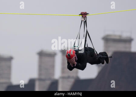 London, UK.  2 December 2016.  A participant takes place in a zip-wire challenge from the roof of St. Thomas' Hospital, over the River Thames to Victoria Tower Gardens next to the Houses of Parliament.  20 participants are each reported to have raised GBP50,000 each to reach GBP1m for the Evelina London Children's Hospital. Credit:  Stephen Chung / Alamy Live News Stock Photo