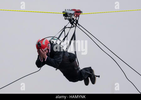 London, UK.  2 December 2016.  A participant takes place in a zip-wire challenge from the roof of St. Thomas' Hospital, over the River Thames to Victoria Tower Gardens next to the Houses of Parliament.  20 participants are each reported to have raised GBP50,000 each to reach GBP1m for the Evelina London Children's Hospital. Credit:  Stephen Chung / Alamy Live News Stock Photo