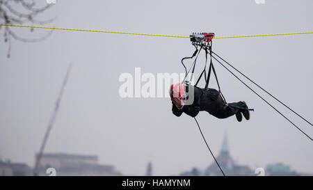 London, UK.  2 December 2016.  A participant takes place in a zip-wire challenge from the roof of St. Thomas' Hospital, over the River Thames to Victoria Tower Gardens next to the Houses of Parliament.  20 participants are each reported to have raised GBP50,000 each to reach GBP1m for the Evelina London Children's Hospital. Credit:  Stephen Chung / Alamy Live News Stock Photo