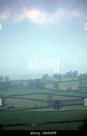 Cool misty conditions over rural farmland in the village of Rhes-y-Cae in Flintshire, North Wales. Stock Photo