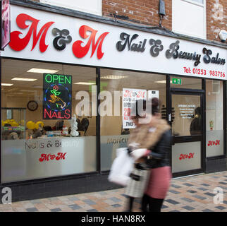 Neon Open sign Nails and People passing Nail Bar & Beauty salon,  in Brierley Street, Blackpool, Lancashire, UK Stock Photo