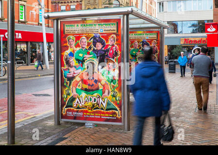 Aladdin Panto   Decorated modern, Bus Shelter, advertising billboard, stop, advertising, poster, urban, empty, public, city, board, transportation, sign, street, placard, road, transport, advertisement, space, panel, roadside, ad, glass, station, commercial, place, marketing banner for Christmas Pantomime, a  Picture Point for the  Grand Theatre, on the streets of Blackpool, Lancashire, UK Stock Photo