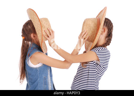 Two pretty twelve year old girls wearing a big floppy straw sun hat isolated on white Stock Photo