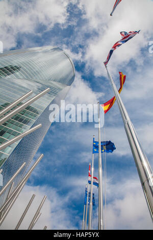 MADRID, SPAIN - MARCH 11, 2013: Skyscraper Torre Espacio and flags. Building was constructed in 2007 and designed by architect Henry N. Cobb. Stock Photo